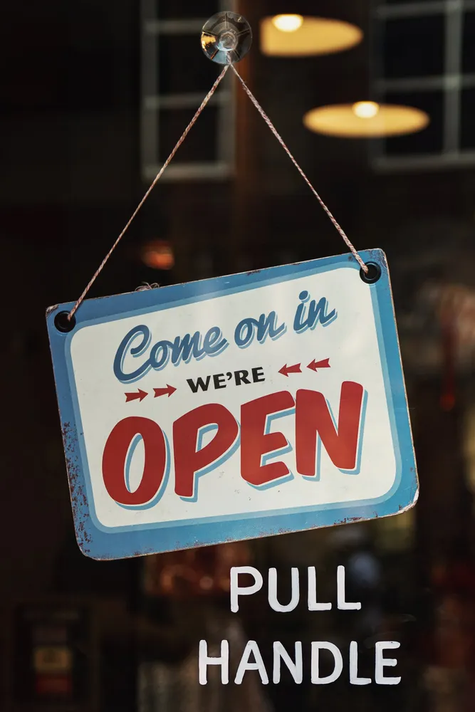 Open for business sign in a shop window
